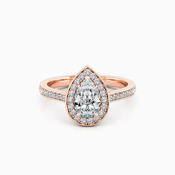 Pear cut diamond engagement ring with pave halo