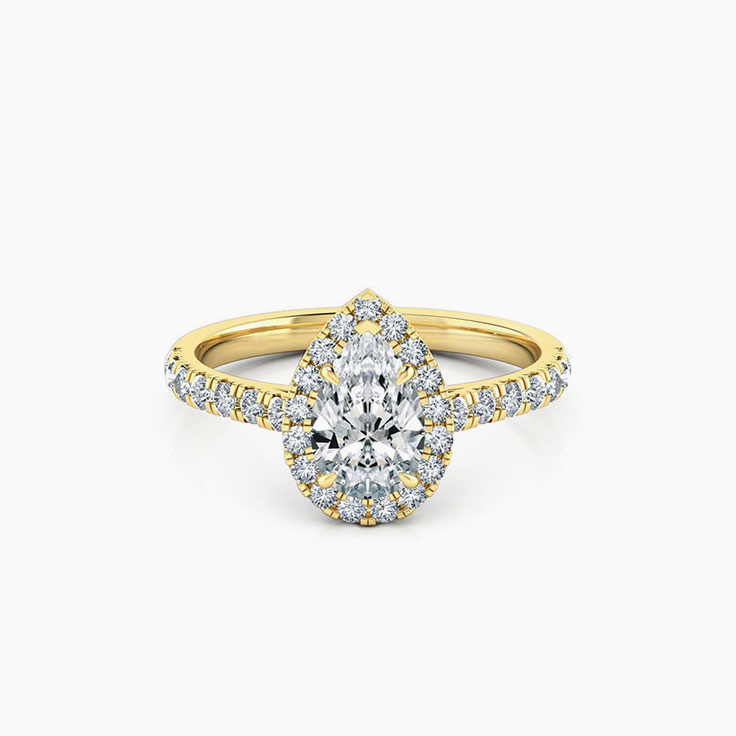 Pear cut diamond engagement ring with halo and diamond band
