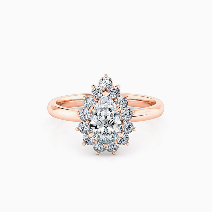 Pear cut diamond engagement ring with a floral diamond halo