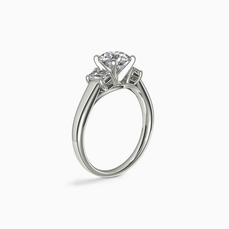 Classic Round Diamond And Emerald Cut Side Stone Engagement Ring